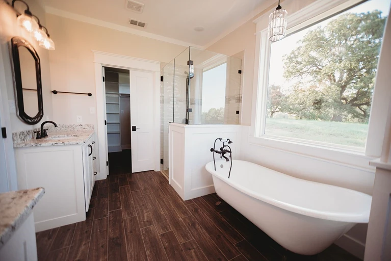 Wood look bathroom floor with standing tub 